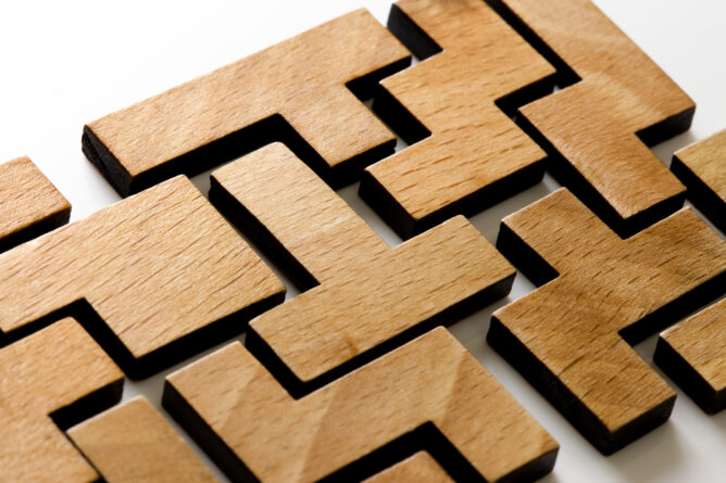Photo of wooden puzzle pieces fitting together.