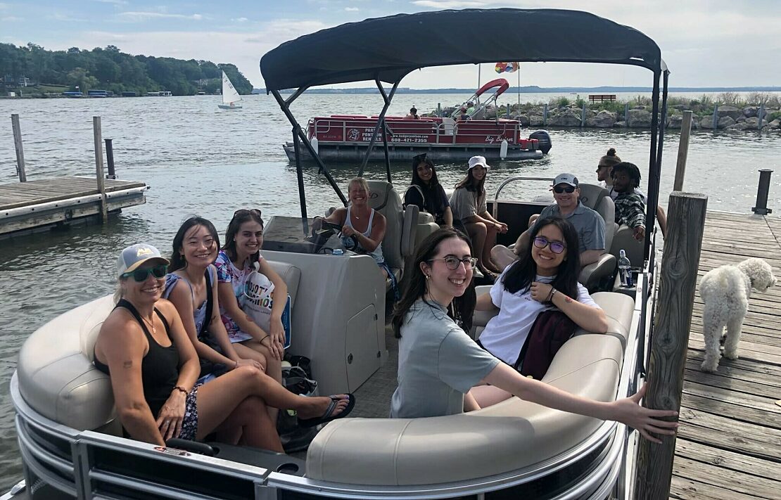 Group photo of EA's 2023 intern cohort on a boat during EA's Summer Week.